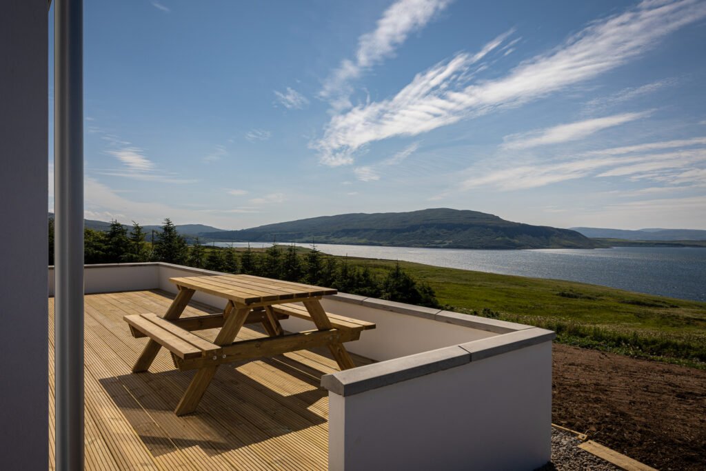 Expansive view of Loch Bay from the deck and picnic bench at Tidal Reach