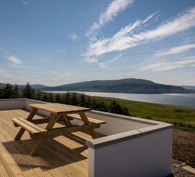 Expansive view of Loch Bay from the deck and picnic bench at Tidal Reach