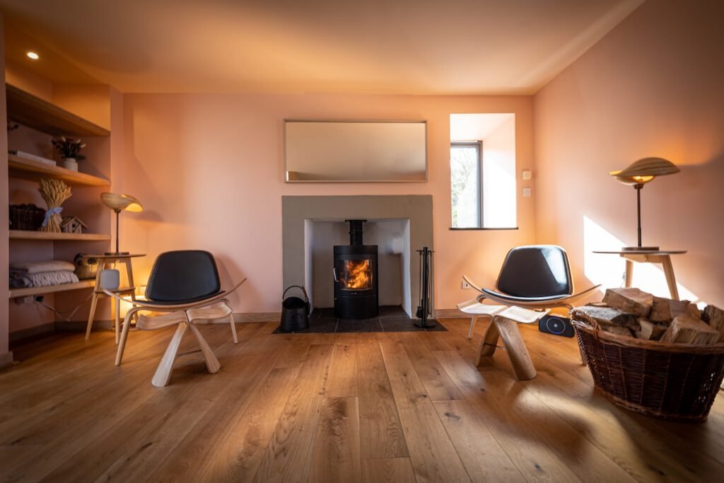 A cosy fireplace inside a warm and stylish living room at Tern House, a Skye and Shore property