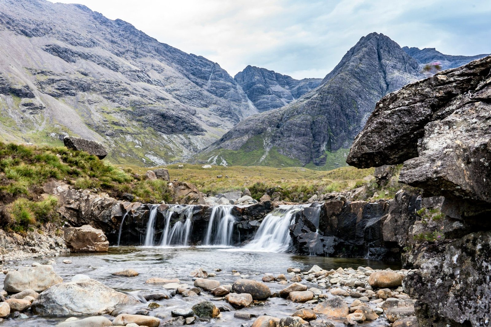 Water cascades over rocks at the Fairy Pools, a famous Isle of Skye attraction easily accessible from all Skye and Shore properties